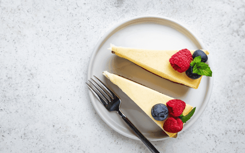Cheesecake filling being mixed with a hand mixer until smooth.