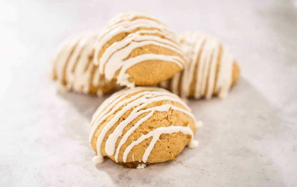 Iced Pumpkin Cookies with a whisk in a bowl