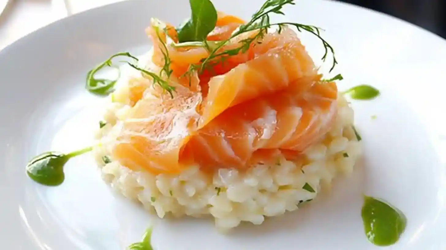 A plate of smoked salmon risotto garnished with fresh dill