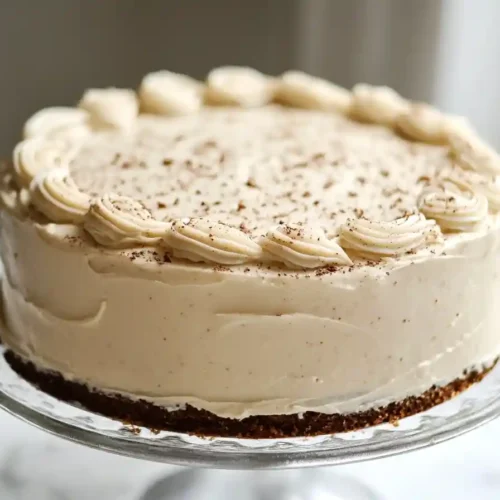 A perfectly baked vanilla almond cake topped with toasted almond slices.