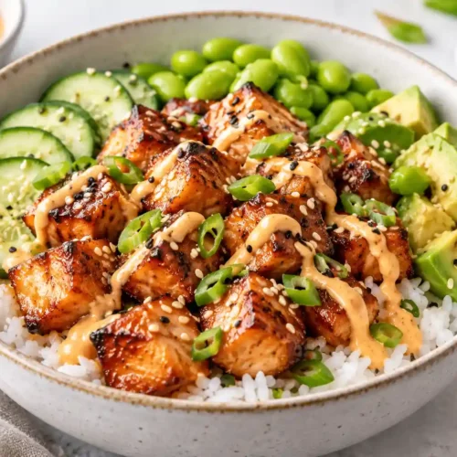 Air fryer salmon bites bowl with jasmine rice, cucumber, avocado, edamame and spicy mayo