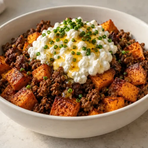 Ground beef sweet potato cottage cheese bowl with crisp sweet potatoes, spiced beef, cottage cheese, hot honey, and chives
